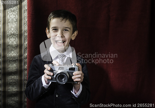 Image of Child taking pictures with vintage camera