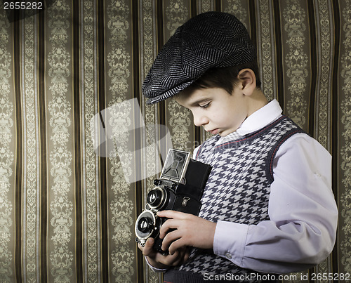 Image of Child taking pictures with vintage camera