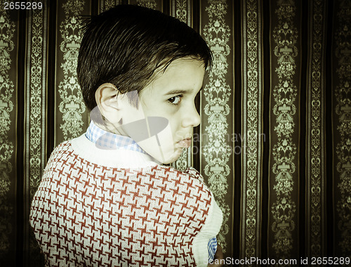 Image of Frowning child vintage clothes.