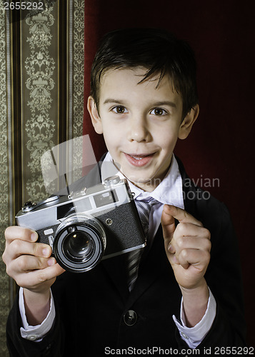 Image of Child taking pictures with vintage camera