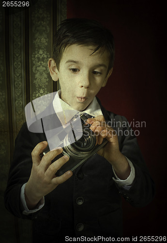 Image of Child taking pictures with vintage camera