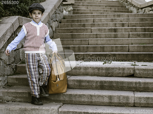 Image of Exterior stairs and child with vintage bag