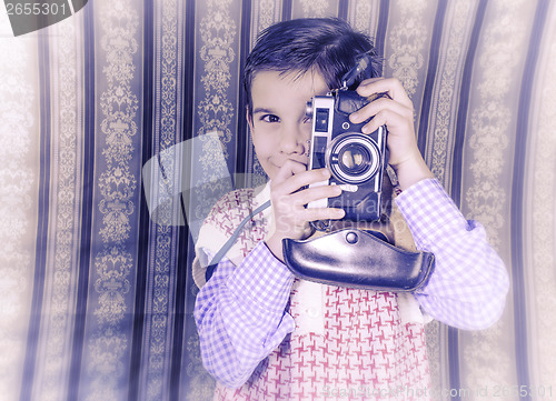 Image of Child taking pictures with vintage camera
