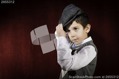 Image of Smiling child in vintage clothes and hat