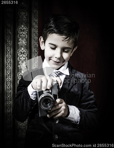Image of Child taking pictures with vintage camera