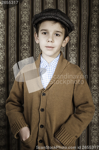 Image of Smiling child in vintage clothes and hat