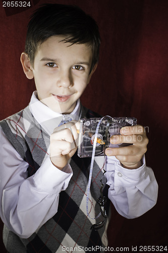 Image of Rolled cassette strip with a pencil. Boy hold cassette tape.