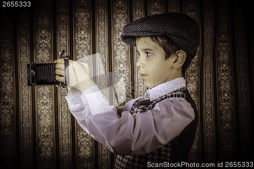 Image of Child taking pictures with vintage camera