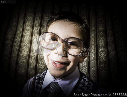 Image of Smiling child with glasses in vintage clothes