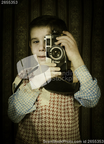 Image of Child taking pictures with vintage camera