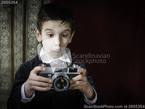 Image of Child taking pictures with vintage camera
