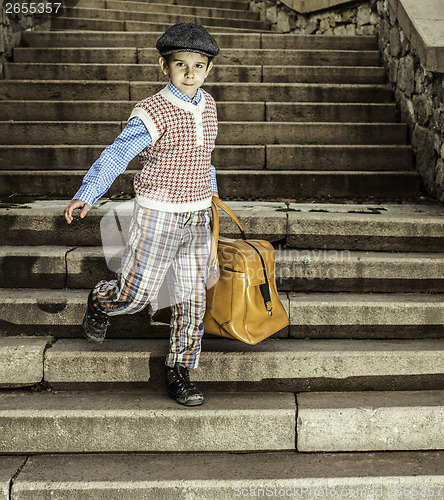 Image of Exterior stairs and child with vintage bag