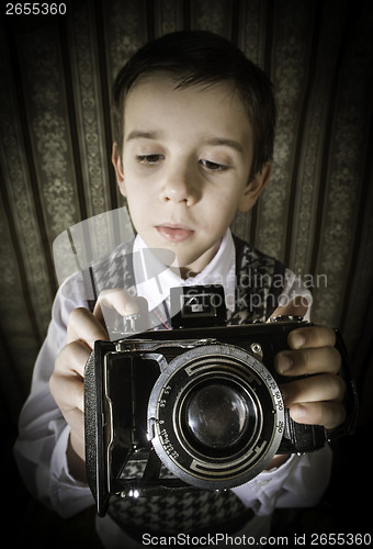 Image of Child taking pictures with vintage camera