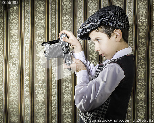 Image of Child taking pictures with vintage camera