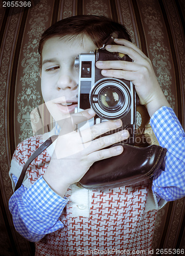 Image of Child taking pictures with vintage camera