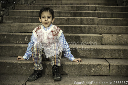 Image of Child sitting on stairs