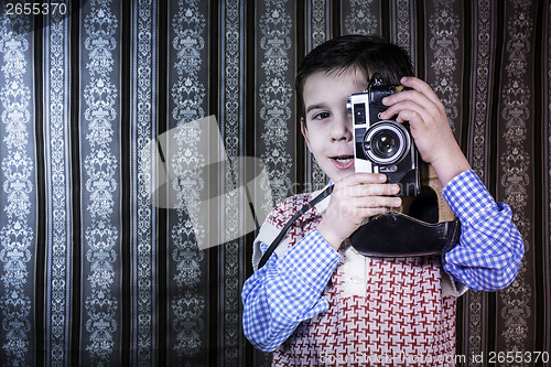 Image of Child taking pictures with vintage camera
