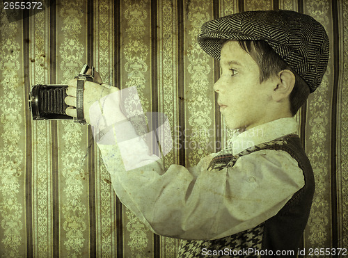 Image of Child taking pictures with vintage camera