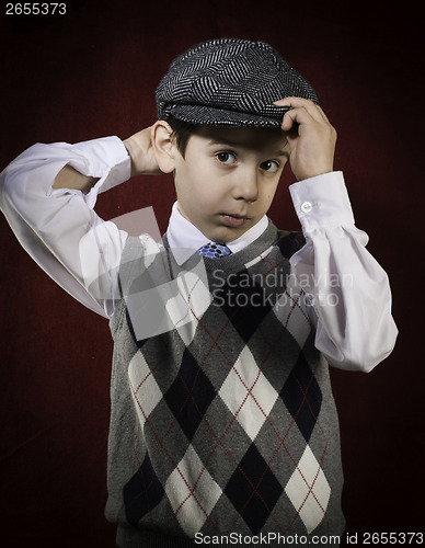 Image of Smiling child in vintage clothes and hat