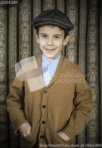 Image of Smiling child in vintage clothes and hat