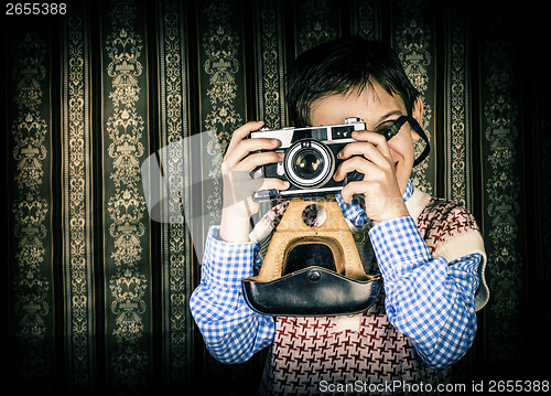 Image of Child taking pictures with vintage camera