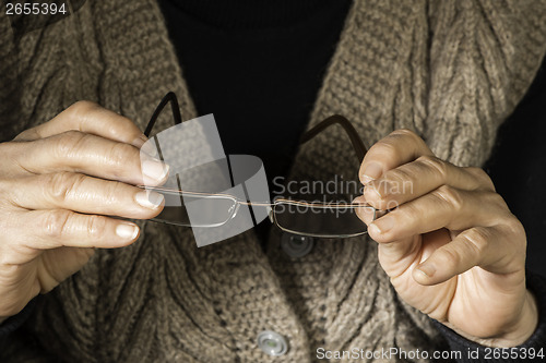 Image of Women hands hold glasses