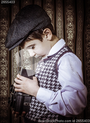 Image of Child taking pictures with vintage camera