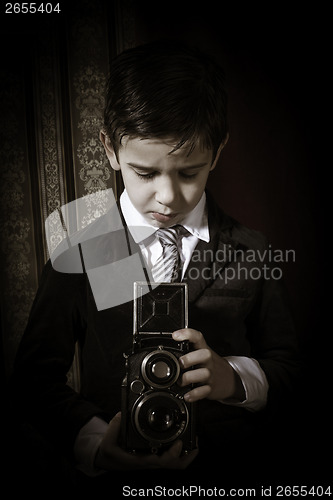 Image of Child taking pictures with vintage camera