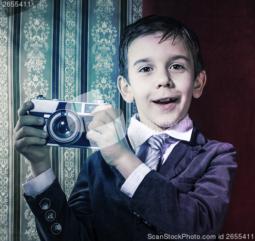 Image of Child taking pictures with vintage camera