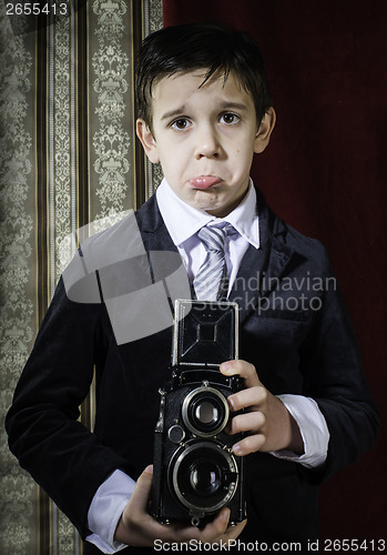 Image of Child taking pictures with vintage camera