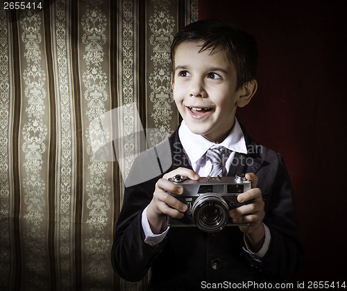 Image of Child taking pictures with vintage camera