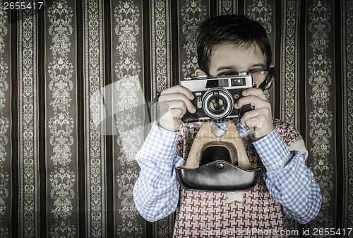 Image of Child taking pictures with vintage camera