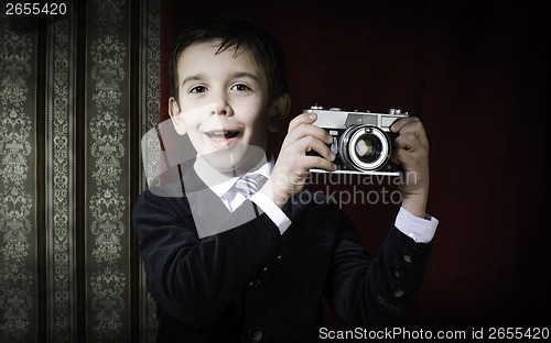 Image of Child taking pictures with vintage camera