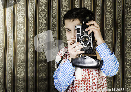 Image of Child taking pictures with vintage camera