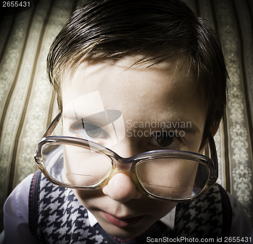 Image of Smiling child with glasses in vintage clothes