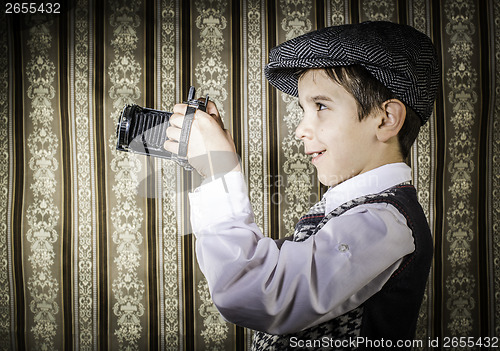 Image of Child taking pictures with vintage camera