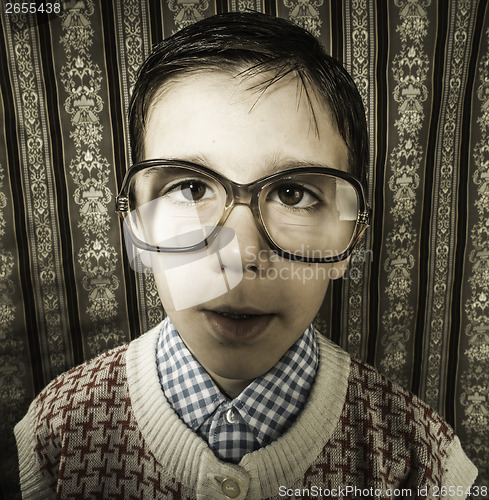 Image of Smiling child with glasses in vintage clothes