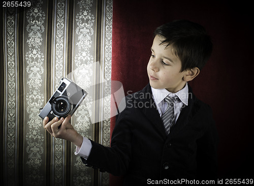Image of Child taking pictures with vintage camera