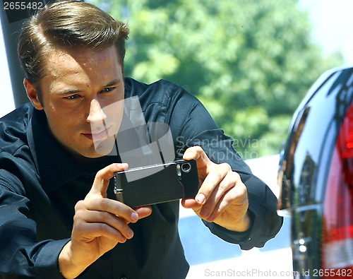 Image of guy taking photo with cellphone