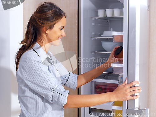 Image of woman in front of the fridge