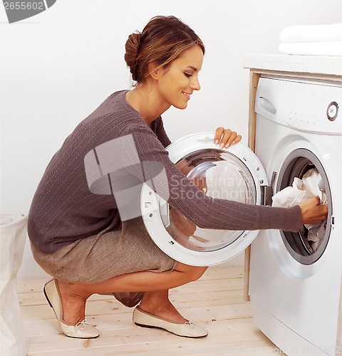 Image of young housewife doing laundry