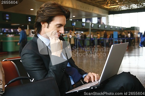 Image of working on laptop at airport