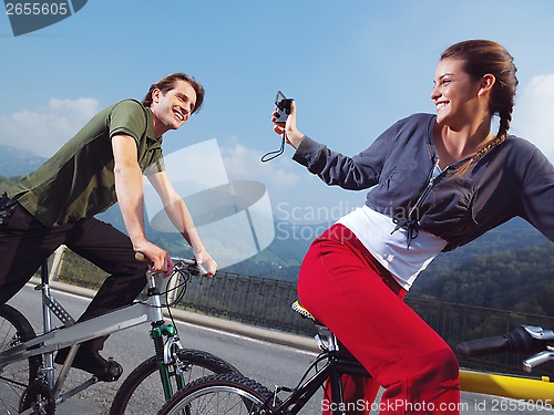 Image of couple on bicycles in the park