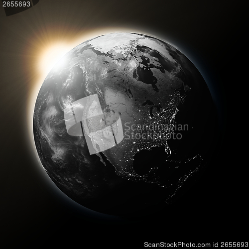 Image of Sun over North America on dark planet Earth