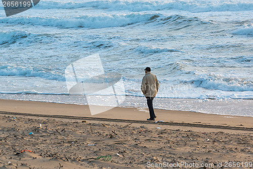 Image of Man Walks Along Coast