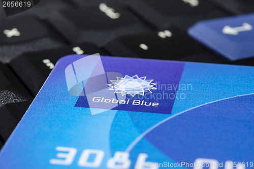 Image of Plastic "Global Blue" card on laptop ThinkPad keyboard