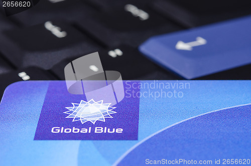 Image of Global Blue closeup logo on plastic card against black ThinkPad 