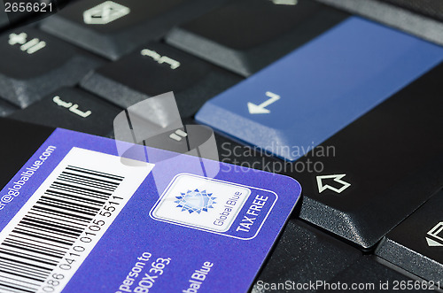 Image of Tax free company Global Blue card on black notebook keyboard