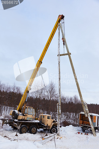 Image of Construction of power lines using a mobile crane 