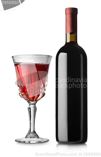 Image of Glass of red wine and bottle